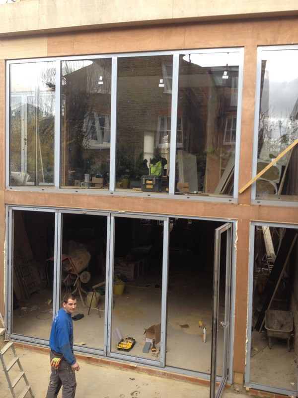Aluminium bi-fold doors with two-storey glazing in Dalston