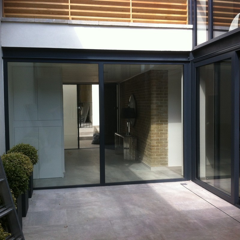 Floor-to-ceiling sliding doors opening to courtyard in Dalston