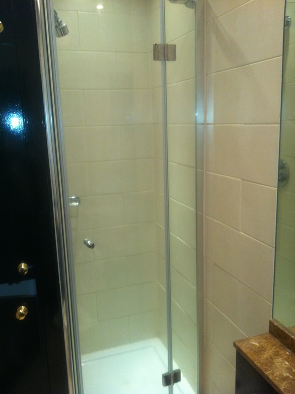 Frameless glass shower enclosure with chrome fittings in Dalston