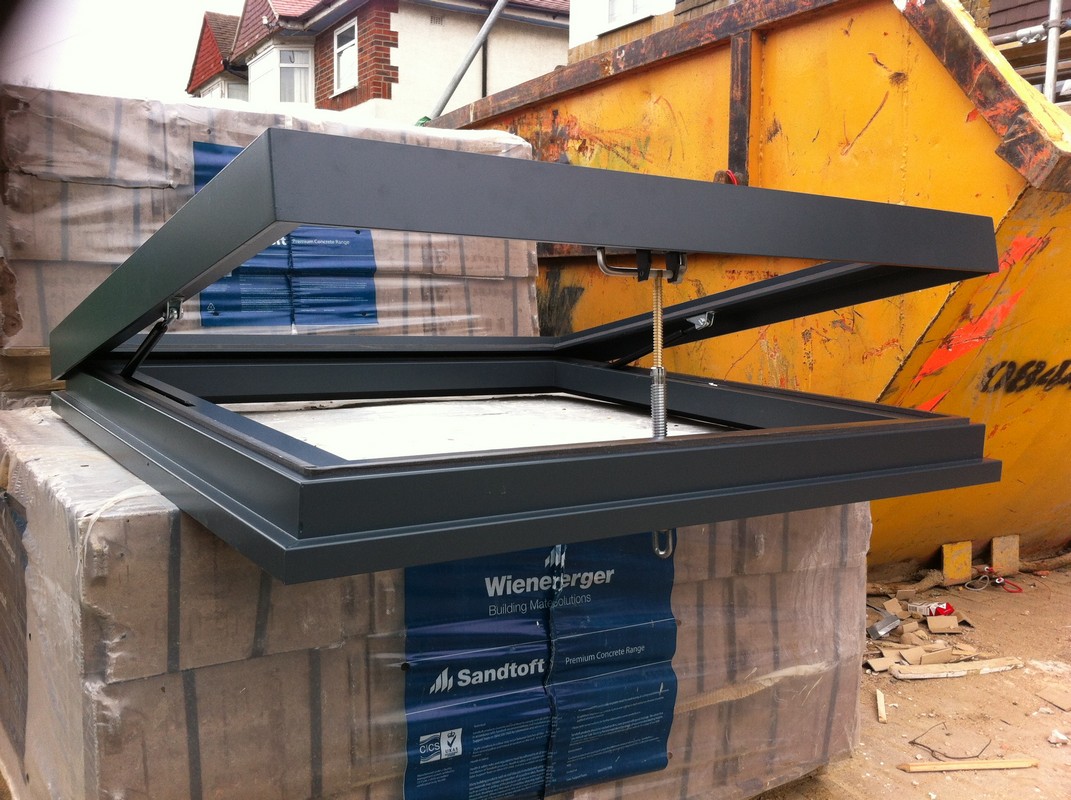 Opening flat roof skylight in anthracite grey installed in Dalston