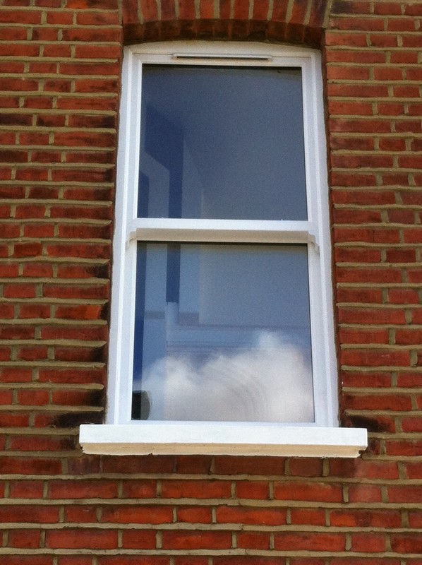 uPVC sash window on Victorian red brick house in Dalston